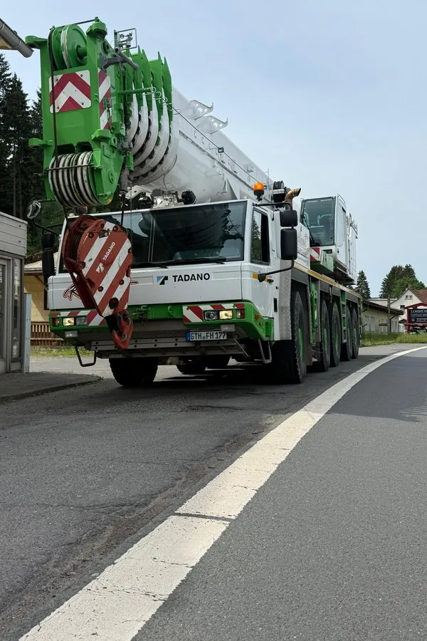 Autokran von Krandienst F&H fährt auf einer Ortsstraße